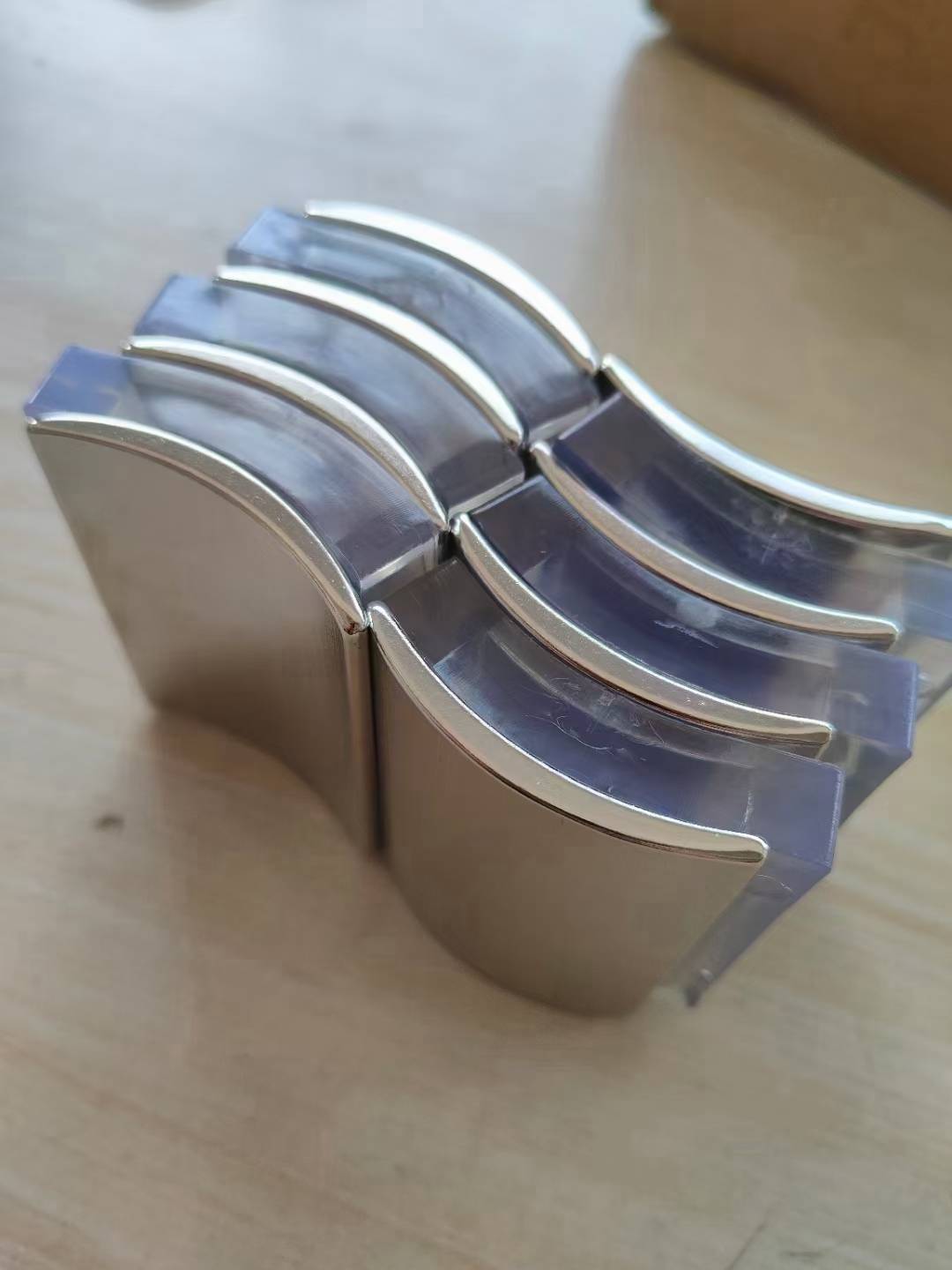 Stacked plated arc magnets with a reflective surface finish